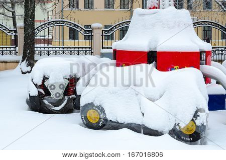 GOMEL BELARUS - JANUARY 12 2017: Snowy attraction "Cars" in winter park during snowfall Gomel Belarus