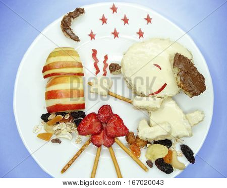 creative breakfast food with fruit and chocolate sweet cream on bread