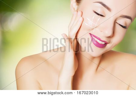 beautiful young woman face with surgery marks