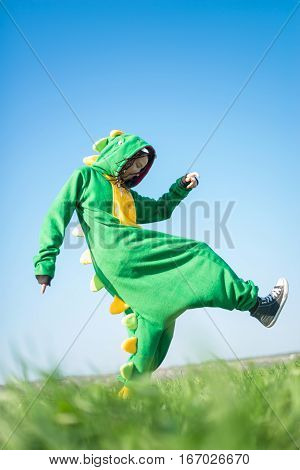 Dragon kigurumi on the green fild, girl