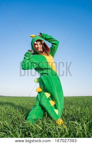 Dragon kigurumi on the green fild, girl
