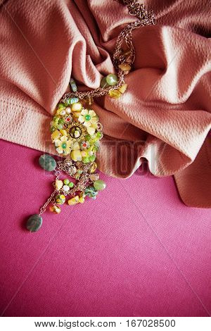 vintage colorful background with granny`s green necklace. Memories concept photo with copy space