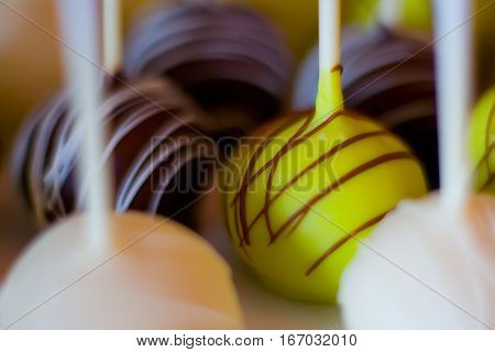 A closeup of a row of cake balls