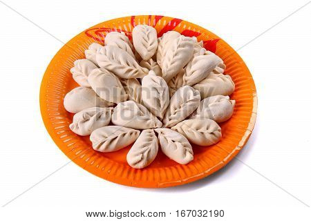 Frozen Vareniki Laying On The Orange Plate
