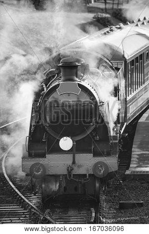 Restored Victorian Era Steam Train Engine With Full Steam In Black And White