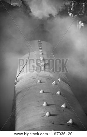 Restored Victorian Era Steam Train Engine With Full Steam In Black And White