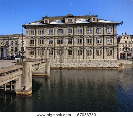 Zurich, Switzerland - 27 January, 2017: the Zurich Town Hall building and Rathausbrucke bridge over the Limmat river. The Zurich Town Hall building (German: Zurich Rathaus) houses the Zurich Cantonal Parliament and the Zurich City Parliament.
