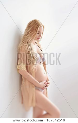 Portrait young pregnant woman with a flower bra