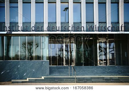 COLOGNE, GERMANY - NOVEMBER 24: The facade and the entrance of the institute of the German economy with logo and glass revolving doors on November 24 2016 in Cologne.