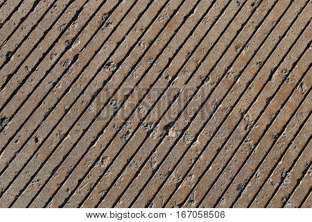 Pavement with diagonal grooves pattern, pits, full frame