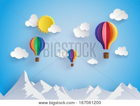 Origami made colorful hot air balloon flyin over moutain with cloud.paper art style.