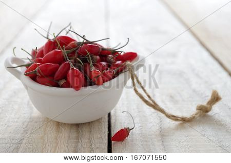 fresh heathy red goji berries of a wooden board