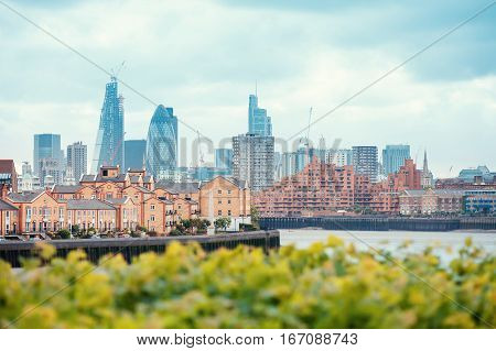 View of London Docklands with the Thames River, downtown and city center. Real estate buildings suburbs
