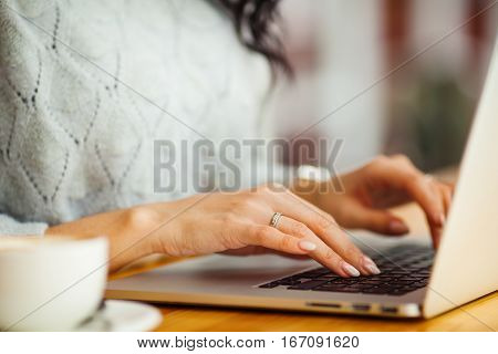female hands typing on a laptop closeup