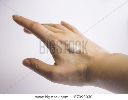 Hands of caucasian woman selfmassage. Hand cream