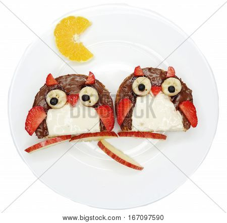 creative breakfast food with fruit and chocolate sweet cream on bread