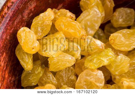 Yellow Raisins Close-up In A Wooden Bowl