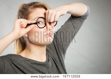 Bad smell concept. Young woman feels disgust pinches her nose with fingers because of odor stench unpleasant stink. Facial reaction.