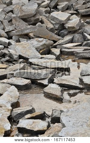 Crushed stone in a river (Details of ruined plaster surface)