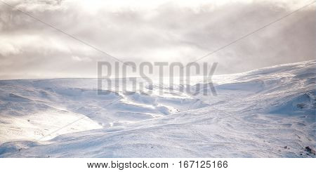 Snowy mountains on the background of daily sunlight.