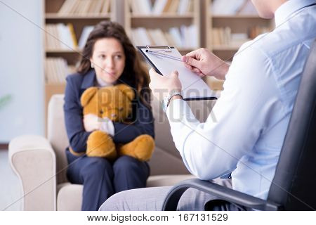 Woman with bear toy during psychologist visit