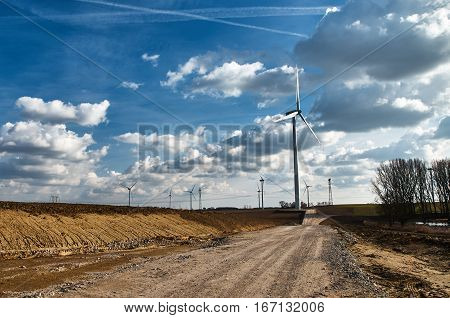 Way to build windmills. White clouds in a blue sky.
