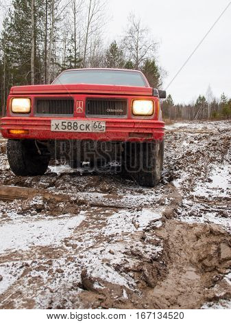 NIZHNY TAGIL. RUSSIA - JUNE 12 2013: The third stage of the Russian Cup for Cross-Country Trials. Wheel drive vehicle leaves the swamp