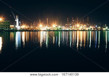 Yachts and boats in marina of La Spezia at night with reflection in water. Italy