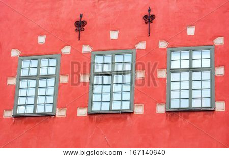 Windows of red iconic buildings on Stortorget, a small public square in Gamla Stan - the old town in central Stockholm ,Sweden
