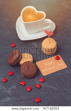 Valentines day concept with macarons over blackboard background