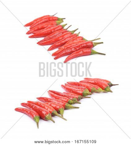 Lined up pile of red italian peppers isolated over the white background, set of two different foreshortenings