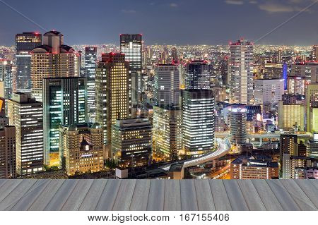Opening wooden floor night lights Osaka city business downtown Japan