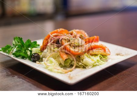 delicious greek salad dressed with olive oil