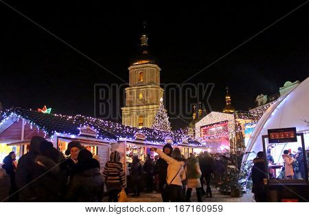 KYIV, UKRAINE - DECEMBER 28, 2014: St. Sophia Cathedral Christmas market and main Kyiv's New Year tree on Sophia Square in Kyiv, Ukraine