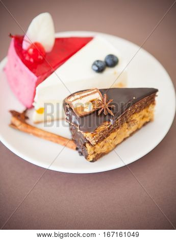 Three various swet dessert cakes on plate