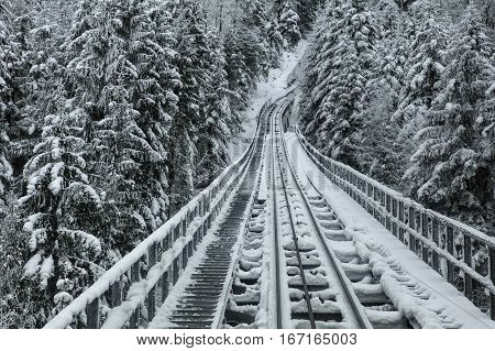 Funicular railway connecting the village of Stoos and the town of Schwyz in Switzerland, on a foggy day in winter.
