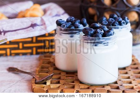 Homemade yogurt with blueberries in a glass jar