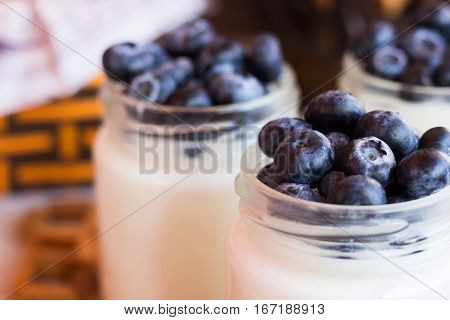 Homemade yogurt with blueberries in a glass jar