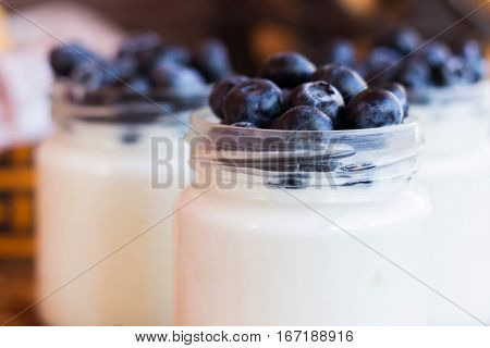 Homemade yogurt with blueberries in a glass jar