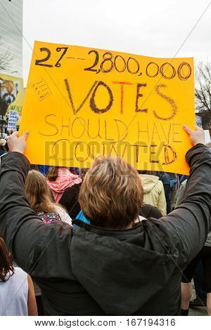 ATLANTA, GA - JANUARY 2017:  A man carries sign that says 