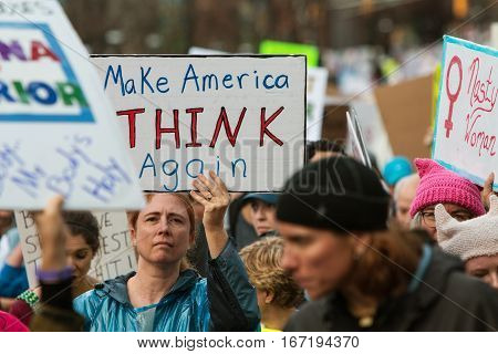 ATLANTA, GA - JANUARY 2017:  A woman holds up sign that says 
