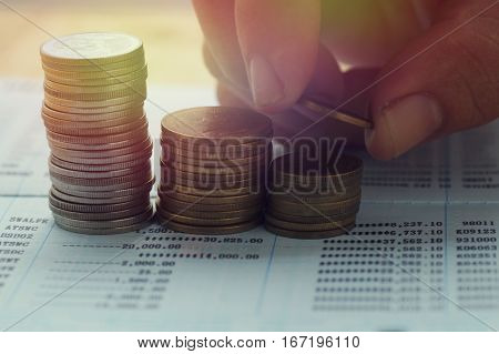 pile coin money with account book finance and banking concept for background.concept in grow and walk step by step for success in business