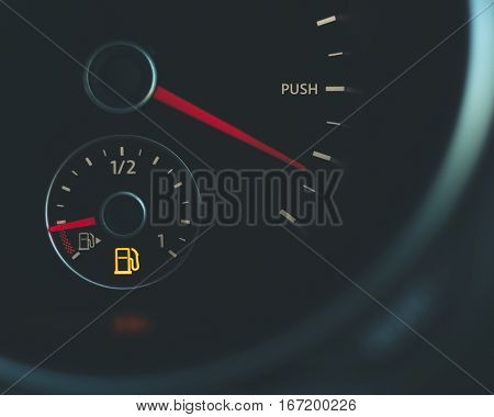 Conceptual image Push Running on empty fuel gauge speedometer