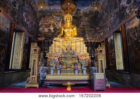 BANGKOK, THAILAND - JANUARY 06, 2017: The altar with the sculpture of a seated Buddha in the bot of Wat Wihan Bovornniwet