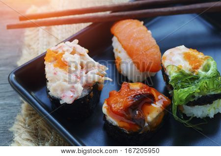 food shushi on black  plate in restaurant