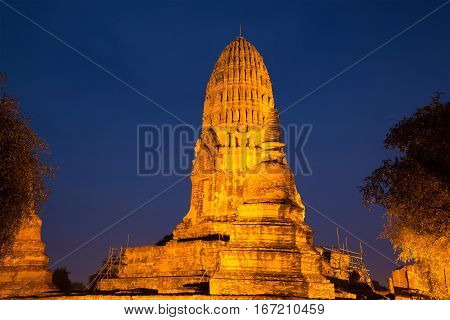 Ancient prang Buddhist temple of Wat Ratcha Burana in night illumination Ayutthaya, Thailand