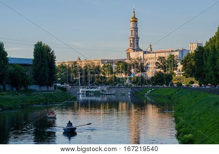 KHARKIV UKRAINE - JULY 06 2016: The bell tower of the Assumption Cathedral (Uspenskiy Sobor) philharmonic organ hall in Kharkiv Ukraine view from the river