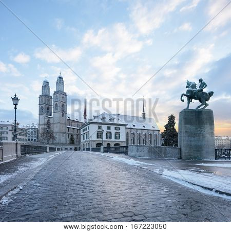 Winter landscape of Zurich. Waldmann monument and Munsterbrucke bridge, Switzerland