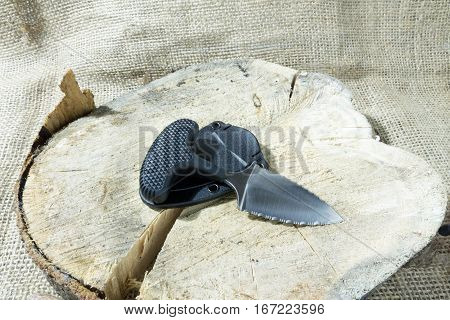 Tactical Knife On Stump With Case. Diagonal Position,