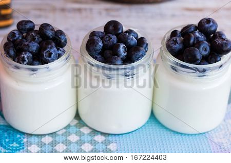 Homemade yogurt with blueberries in a glass jar